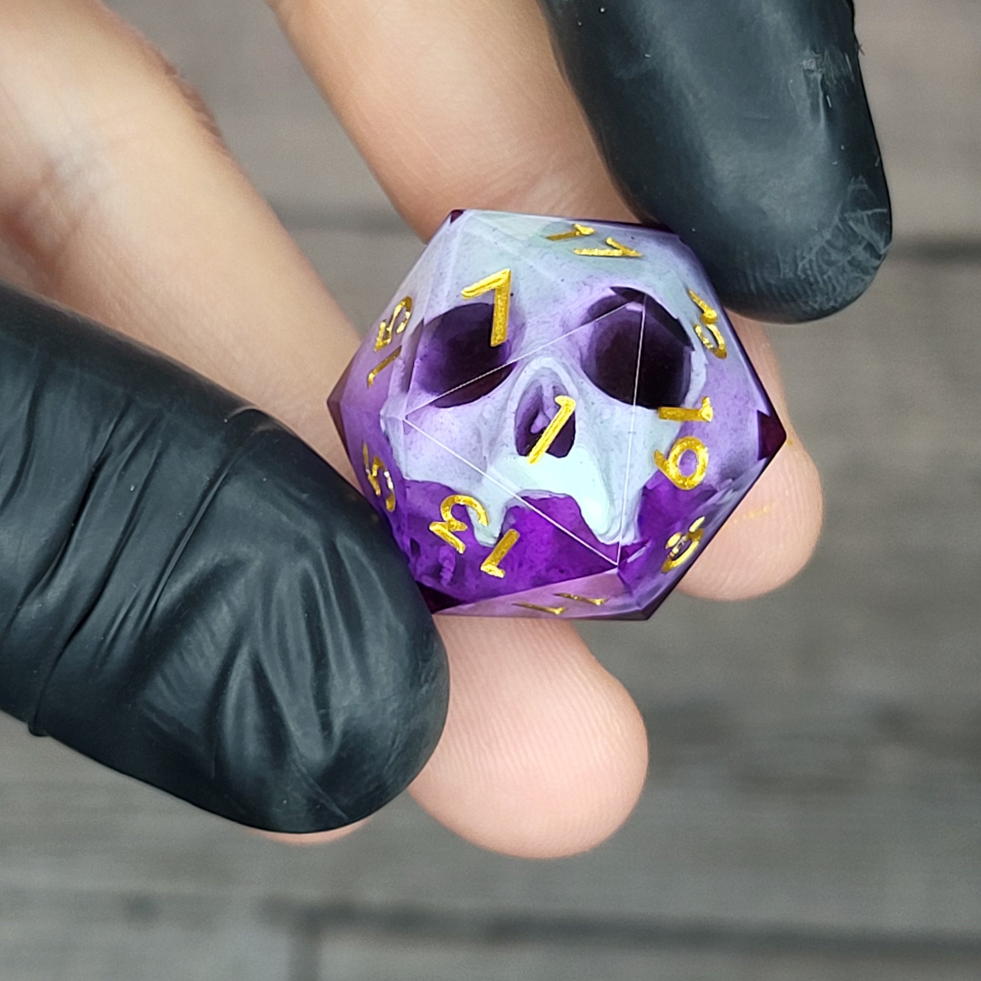 This is a single set of one D20 DnD die with a light green skull inside , purple resin and gold numbers