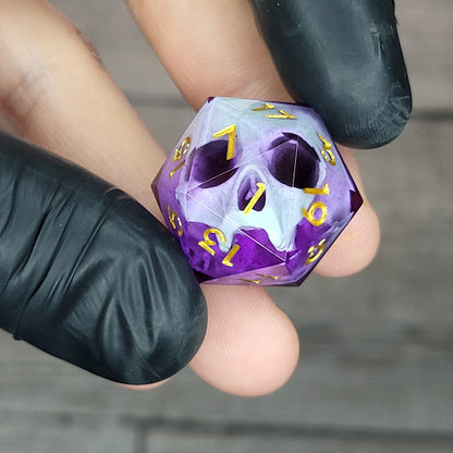 This is a single set of one D20 DnD die with a light green skull inside , purple resin and gold numbers
