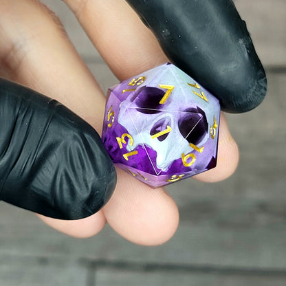 This is a single set of one D20 DnD die with a light green skull inside , purple resin and gold numbers