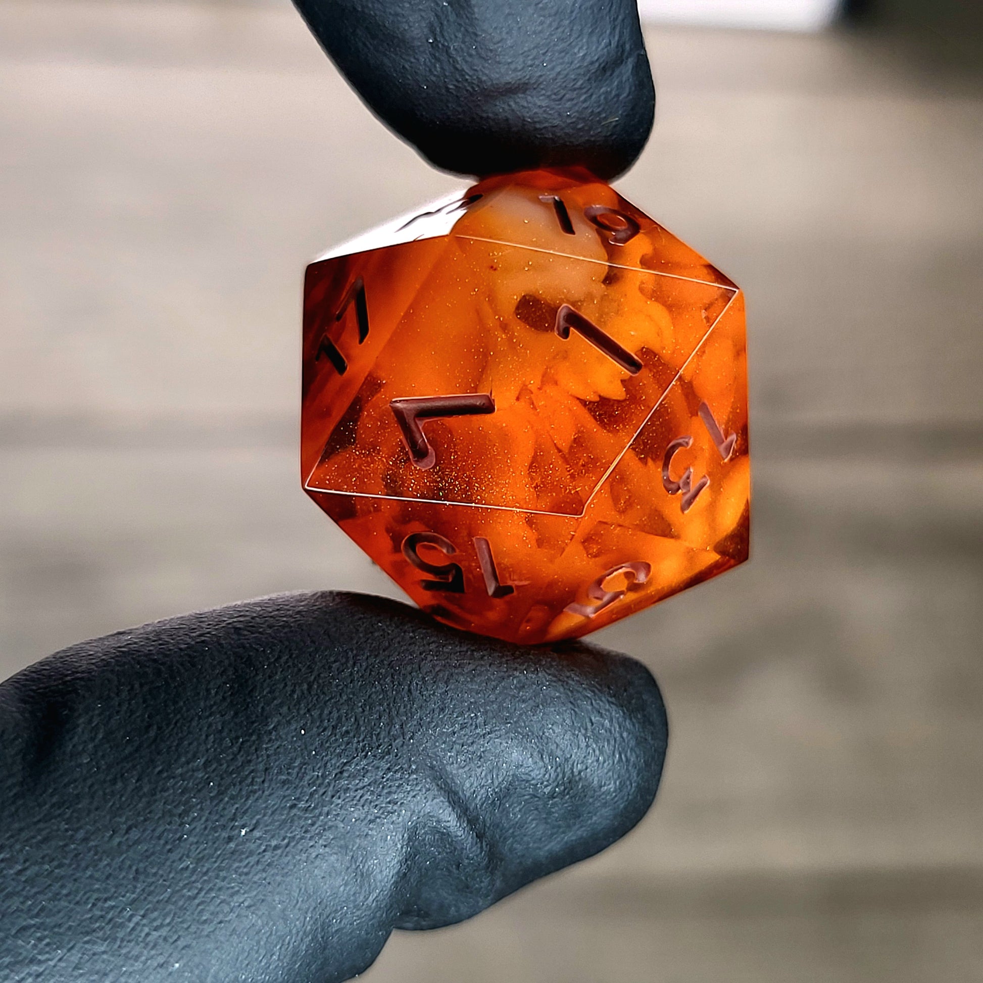 This is a single set of one D20 DnD die with a white spirit inside , orange resin and red numbers