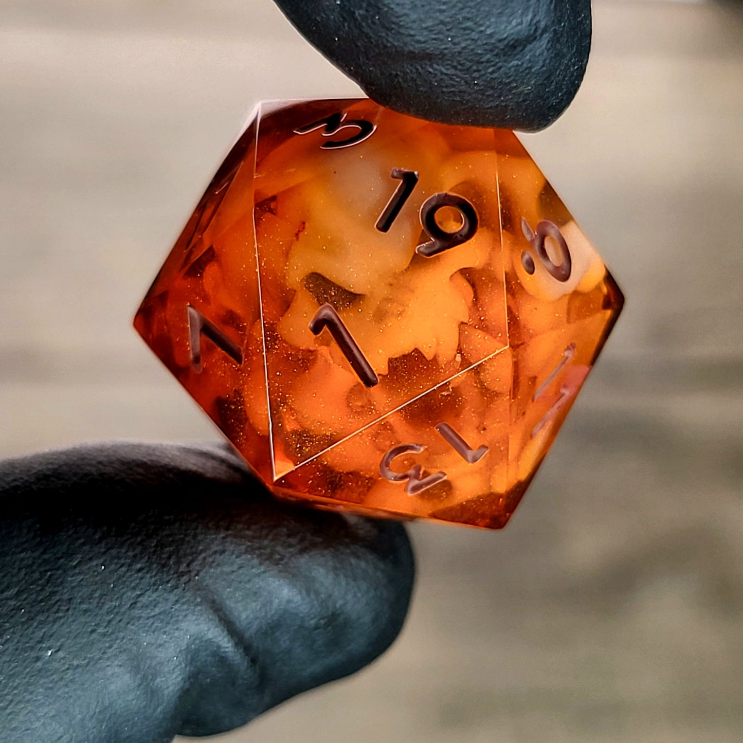 This is a single set of one D20 DnD die with a white spirit inside , orange resin and red numbers