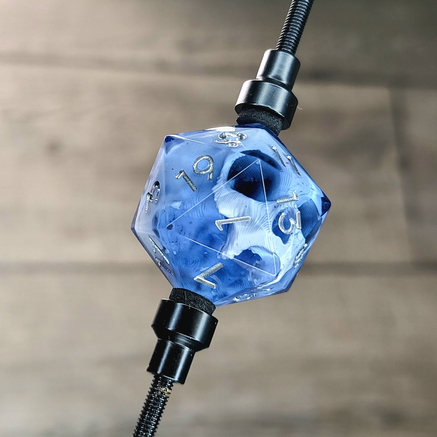 This is a single set of one D20 DnD die with a white skull inside , black resin and silver numbers