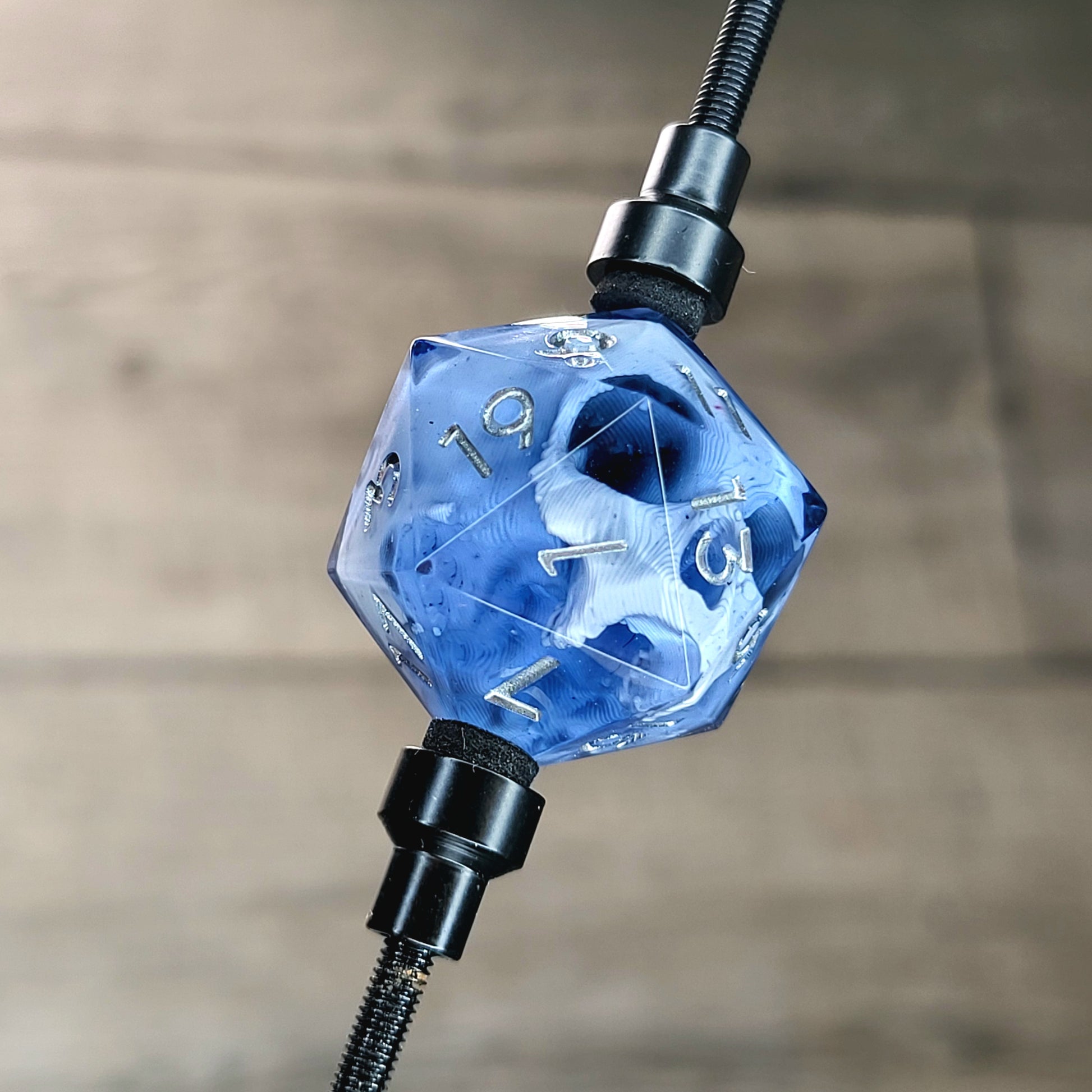 This is a single set of one D20 DnD die with a white skull inside , black resin and silver numbers