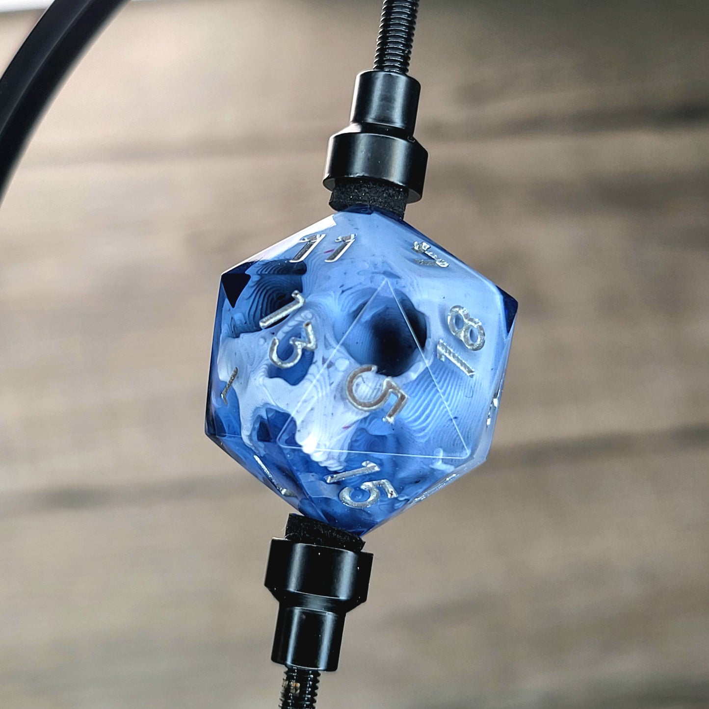 This is a single set of one D20 DnD die with a white skull inside , black resin and silver numbers