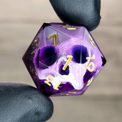 This is a single set of one D20 DnD die with a white skull inside , purple resin and gold numbers
