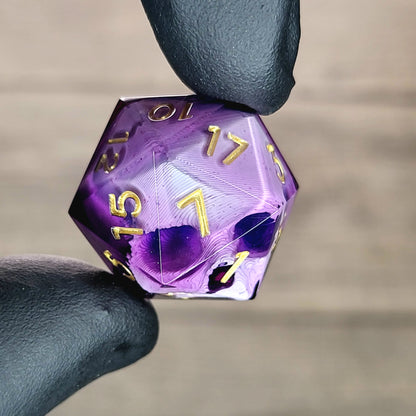 This is a single set of one D20 DnD die with a white skull inside , purple resin and gold numbers