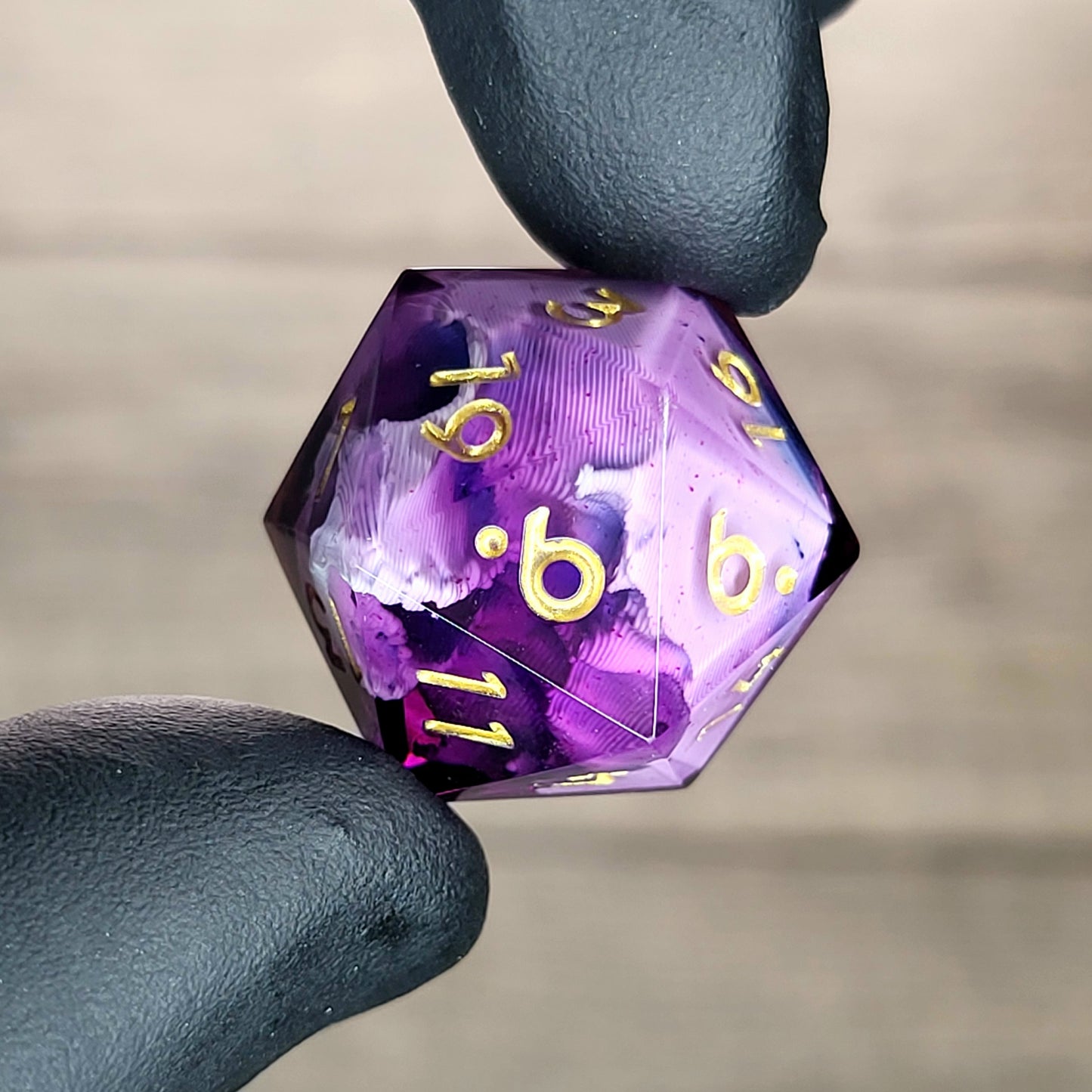This is a single set of one D20 DnD die with a white skull inside , purple resin and gold numbers