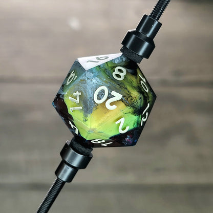 This is a single set of one D20 DnD die with a yellow skull inside , black and white resin and gold and grey number