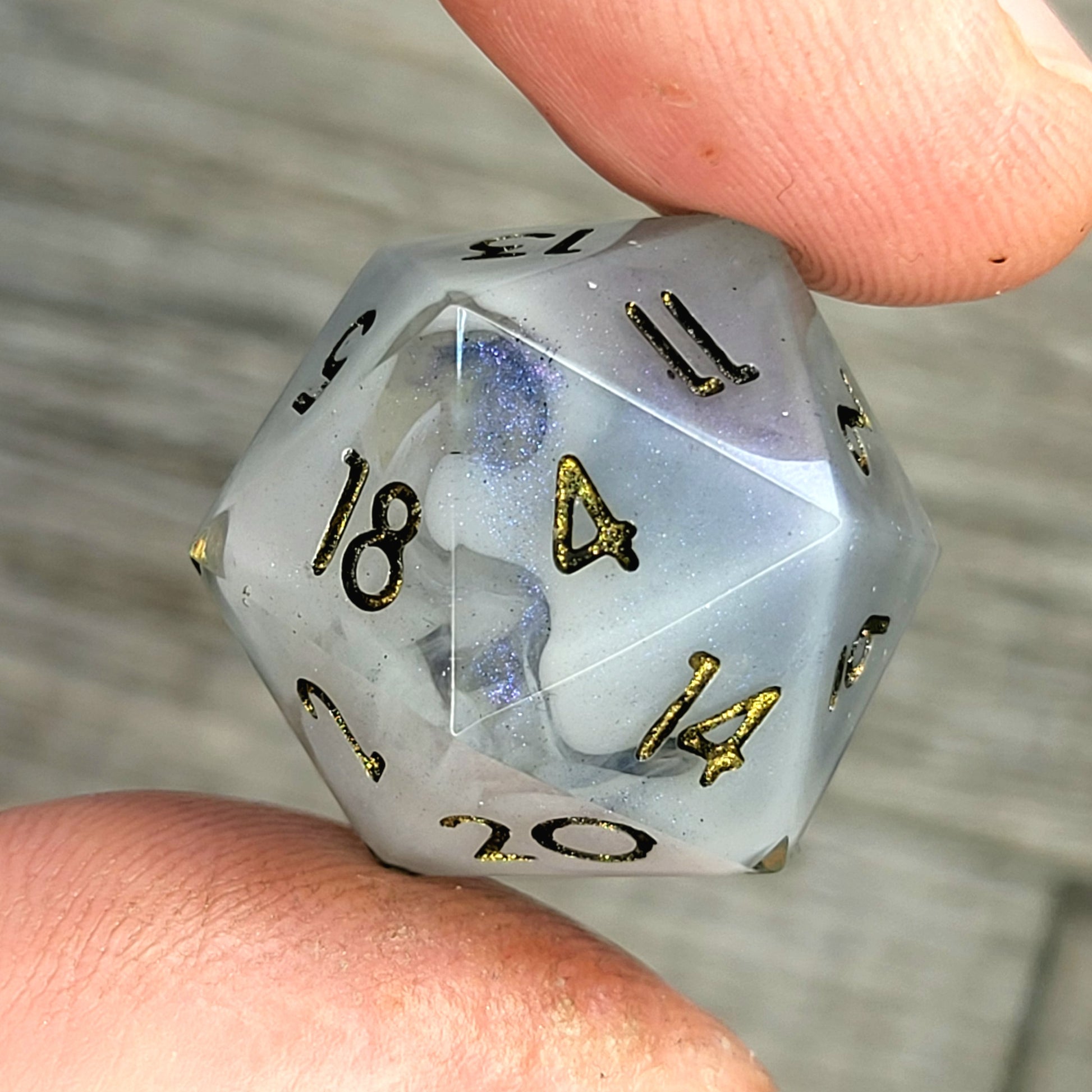 D20 dice with blue white galaxy color inside , black and gold numbers for play dnd , dungeons and dragons