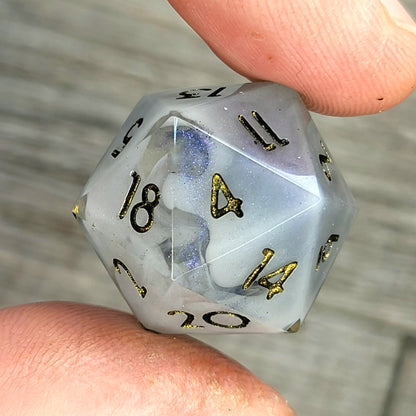 D20 dice with blue white galaxy color inside , black and gold numbers for play dnd , dungeons and dragons