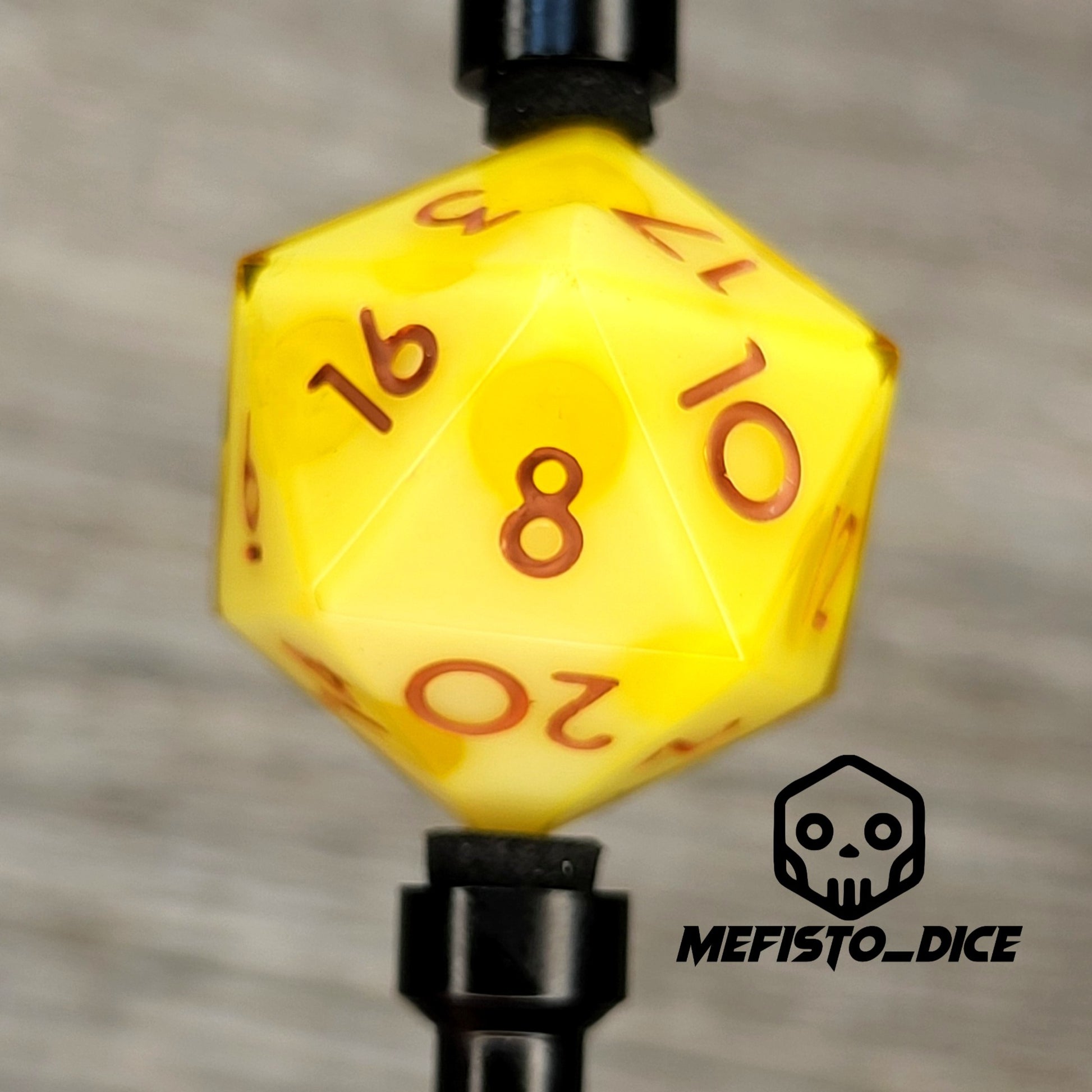 This is a single set of one D20 DnD die with a yellow cheese inside , brown numbers