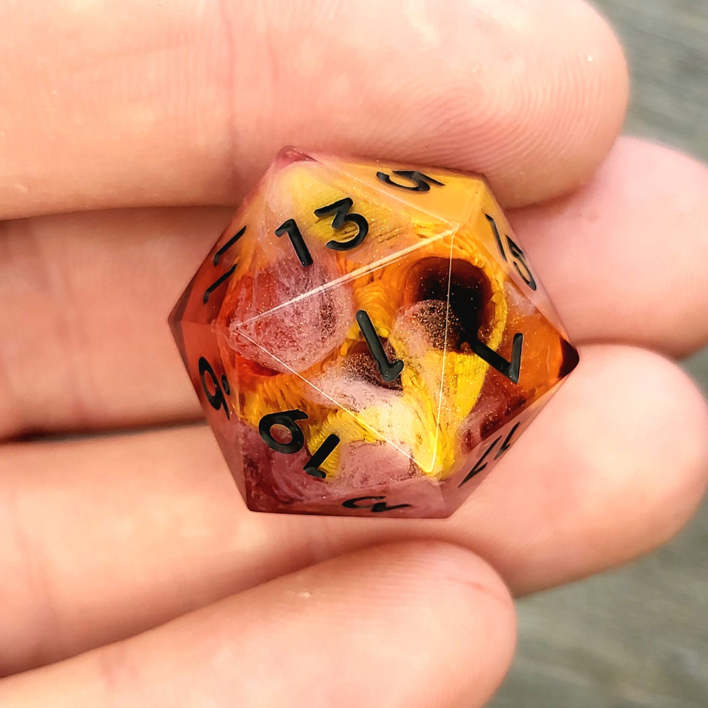 D20 dice with gold skull inside , black numbers for play dnd , dungeons and dragons