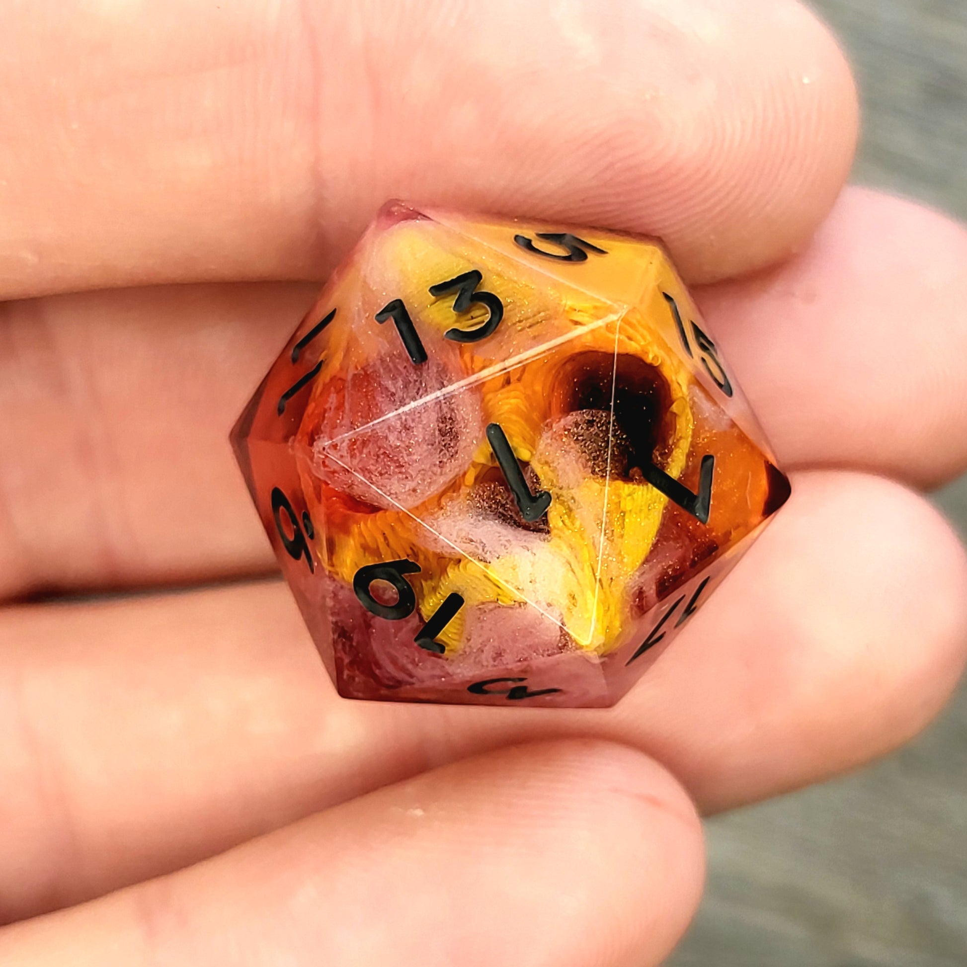 D20 dice with gold skull inside , black numbers for play dnd , dungeons and dragons