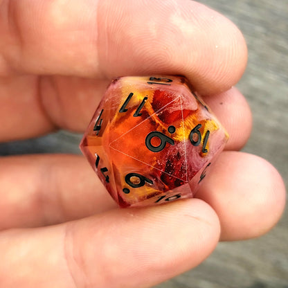 D20 dice with gold skull inside , black numbers for play dnd , dungeons and dragons