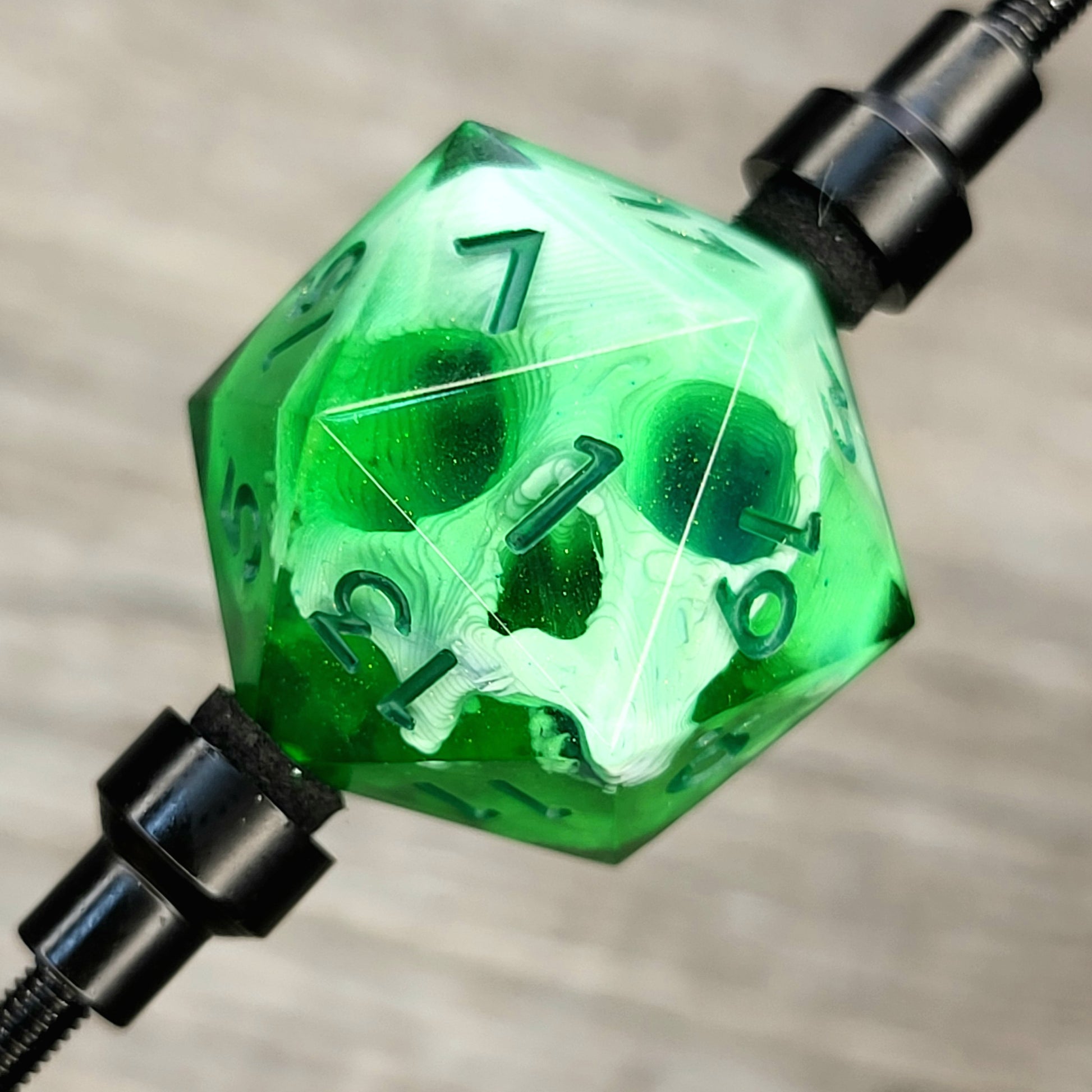 This is a single set of one D20 DnD die with a white skull inside , green resin and green number