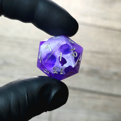 This is a single set of one D20 DnD die with a white skull inside , purple resin and grey numbers
