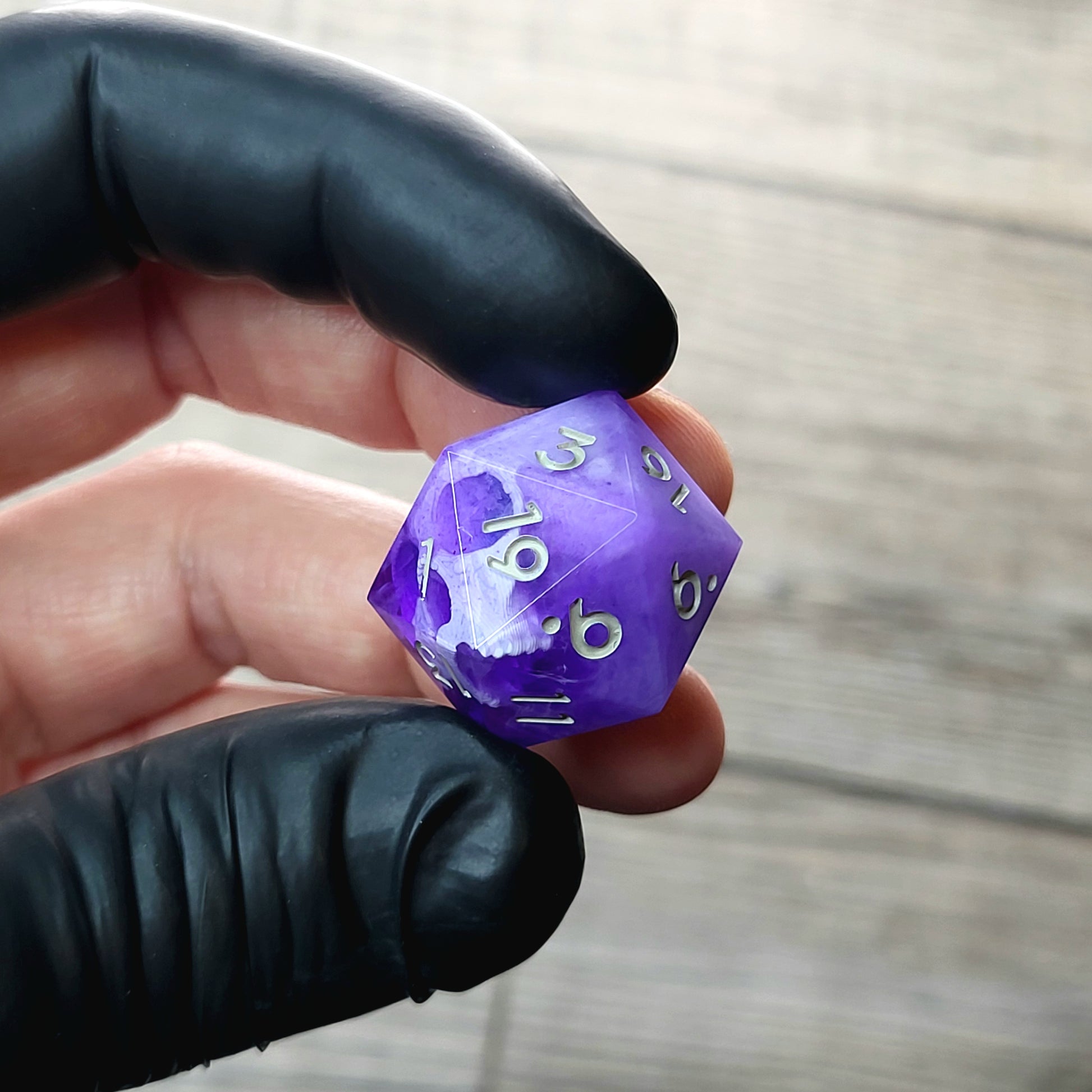 This is a single set of one D20 DnD die with a white skull inside , purple resin and grey numbers