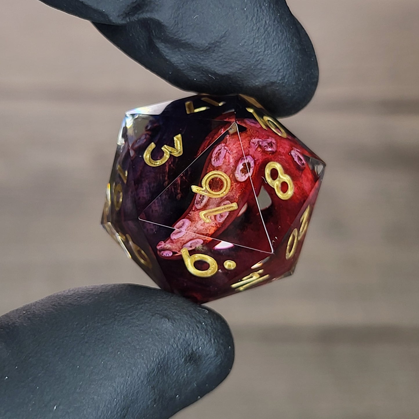 D20 dice with red and blue tentacles inside and gold numbers for play dnd , dungeons and dragons