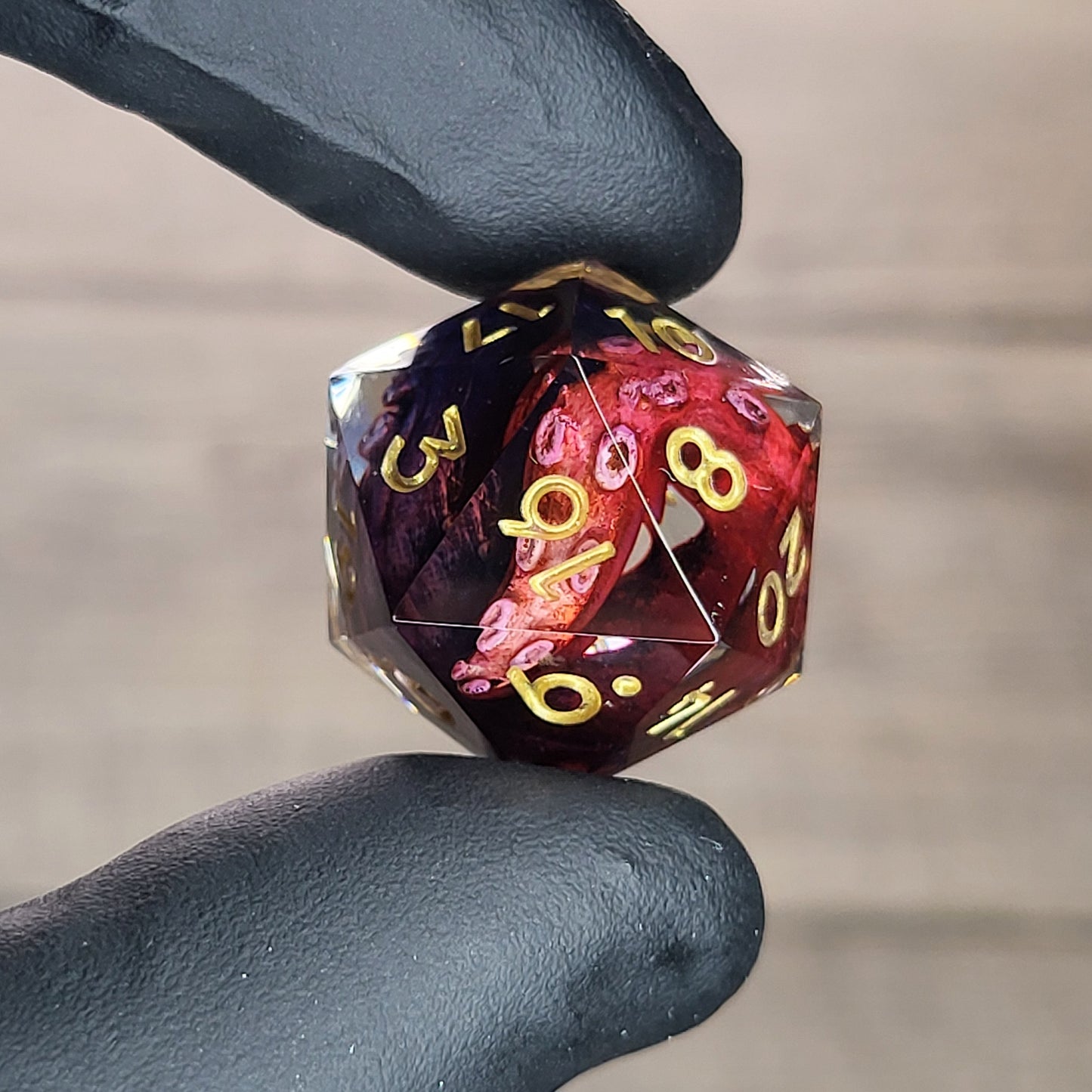 D20 dice with red and blue tentacles inside and gold numbers for play dnd , dungeons and dragons