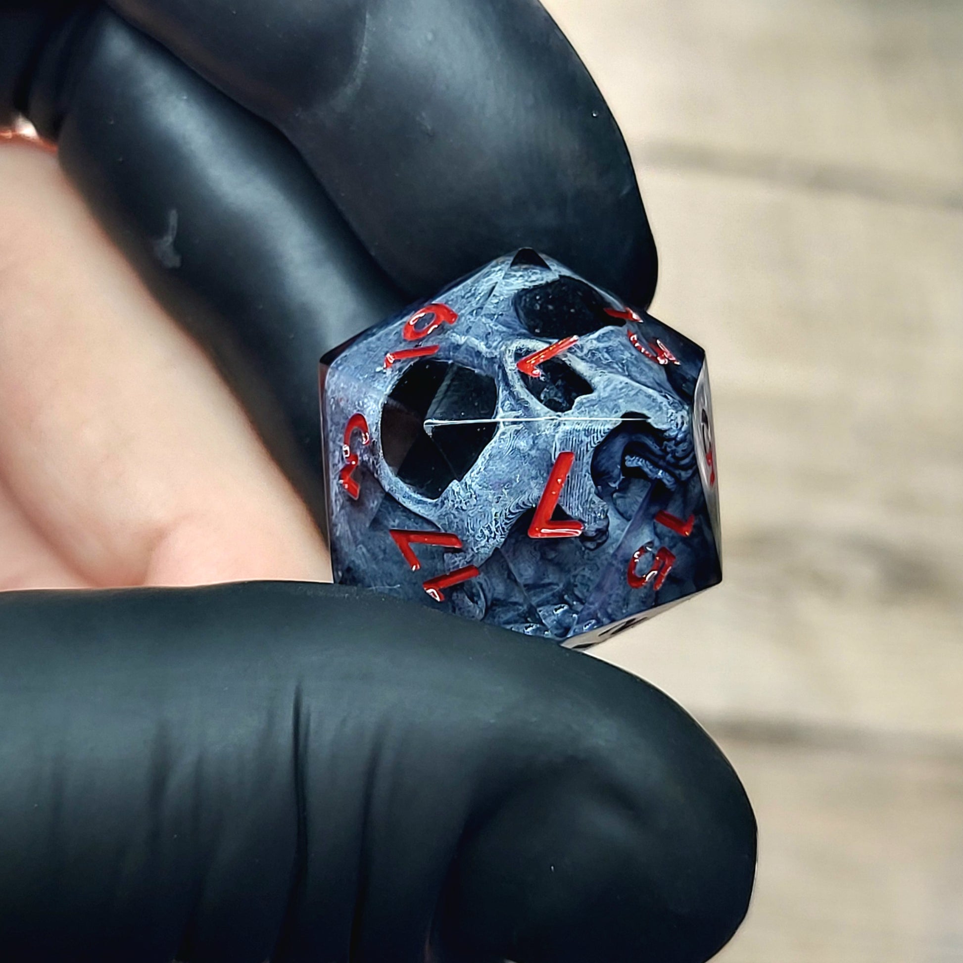 This is a single set of one D20 DnD die with a dark grey skull inside ,black resin and red numbers