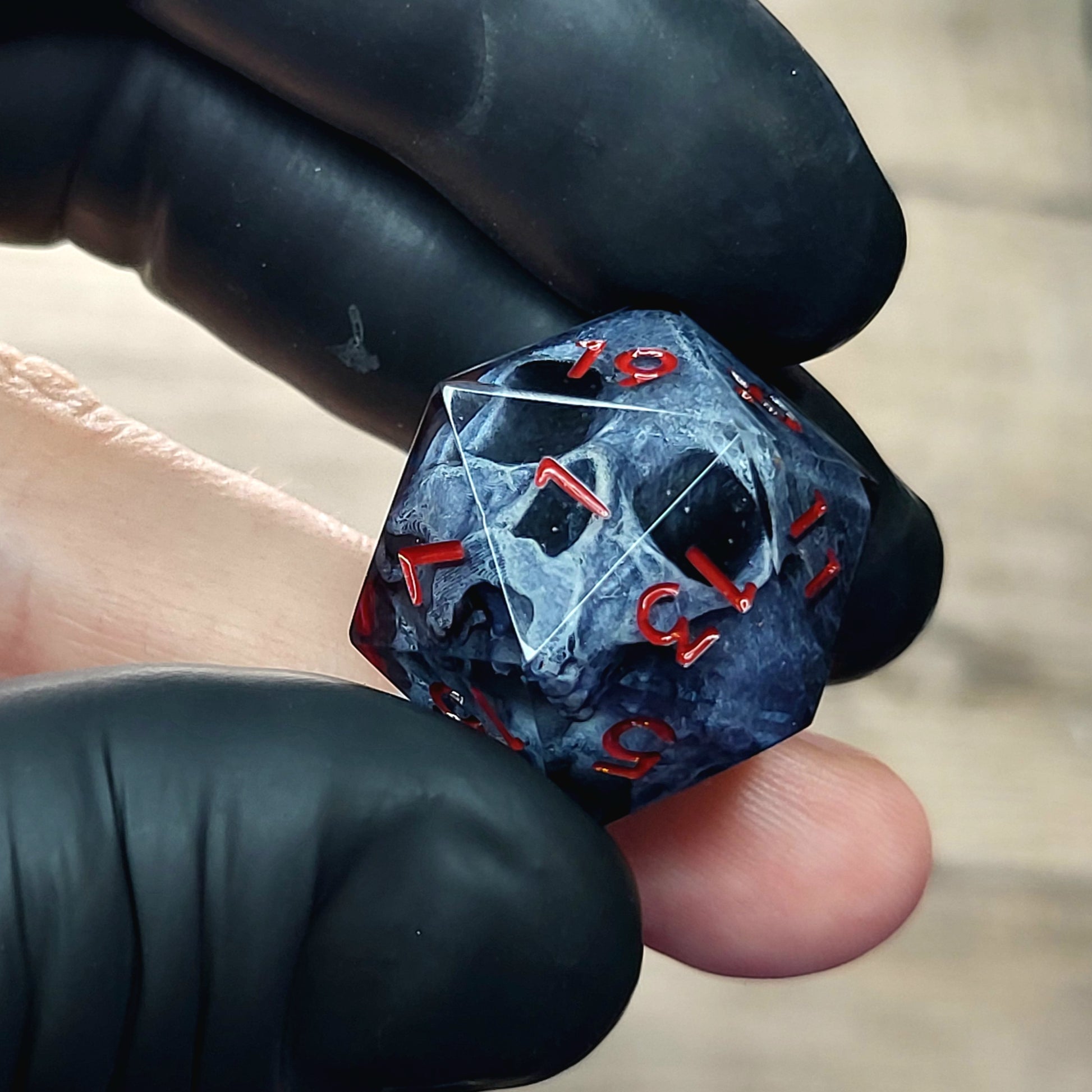 This is a single set of one D20 DnD die with a dark grey skull inside ,black resin and red numbers