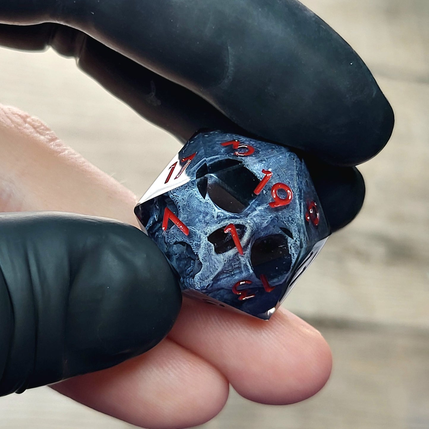This is a single set of one D20 DnD die with a dark grey skull inside ,black resin and red numbers
