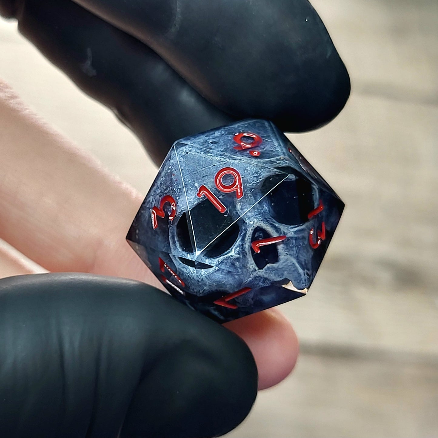 This is a single set of one D20 DnD die with a dark grey skull inside ,black resin and red numbers