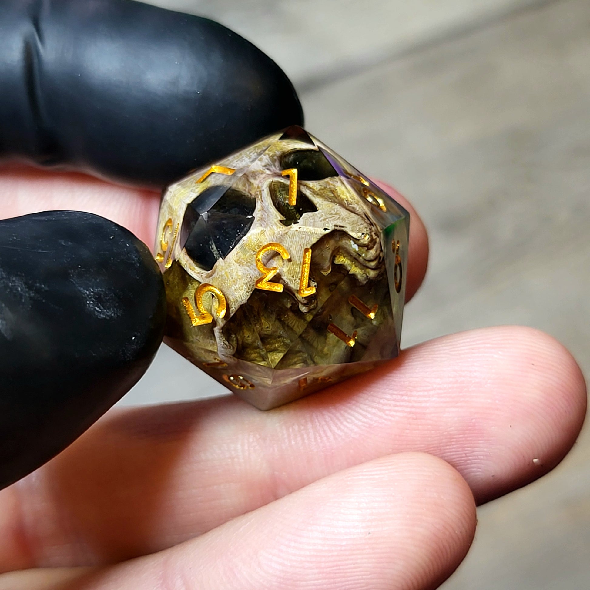 This is a single set of one D20 DND die with a light brown skull inside ,black resin and gold numbers