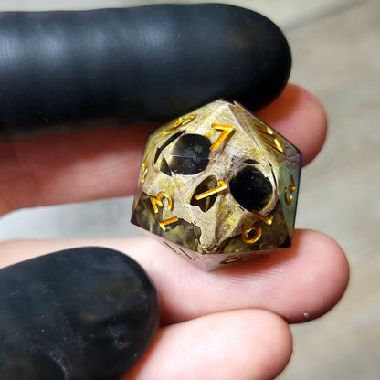 This is a single set of one D20 DND die with a light brown skull inside ,black resin and gold numbers