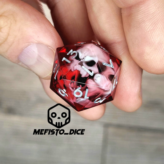 Red resin DnD dice with white skull inside and silver engraved numbers