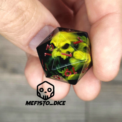 Black resin DnD dice with yellow skull inside and red engraved numbers