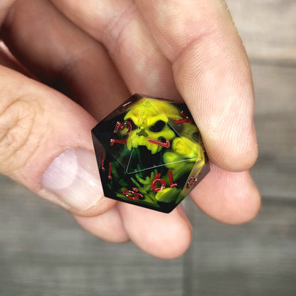 Black resin DnD dice with yellow skull inside and red engraved numbers