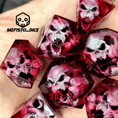 Handmade sharp edge resin dice set with floating skull inclusions in transparent crimson red resin