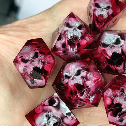 Handmade sharp edge resin dice set with floating skull inclusions in transparent crimson red resin