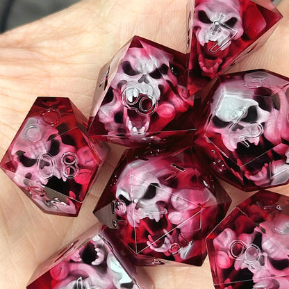 Handmade sharp edge resin dice set with floating skull inclusions in transparent crimson red resin