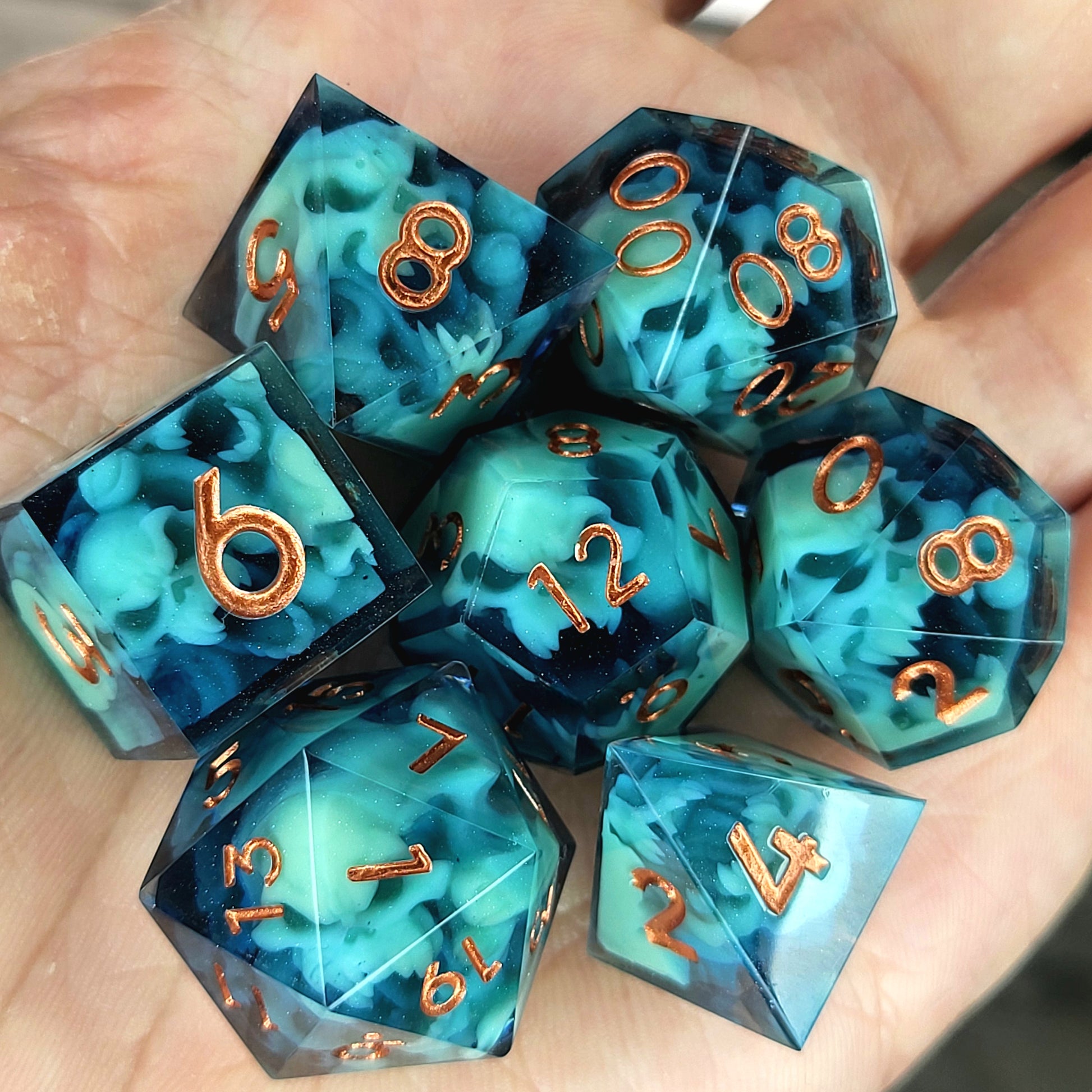 Dice set with green spirit inside and bronze numbers for play dnd , dungeons and dragons