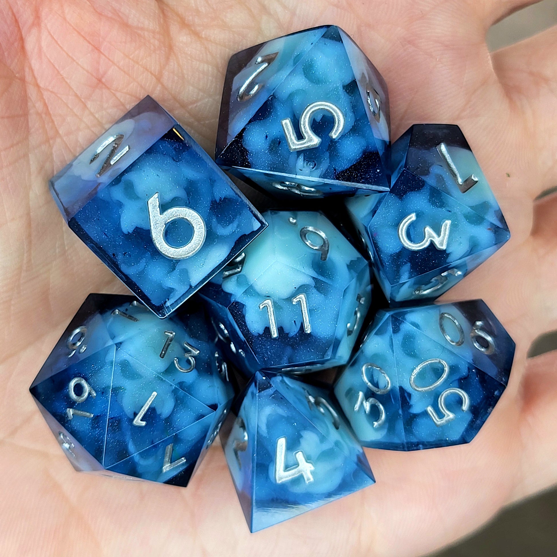 Dice set with light blue spirit inside and silver numbers for play dnd , dungeons and dragons