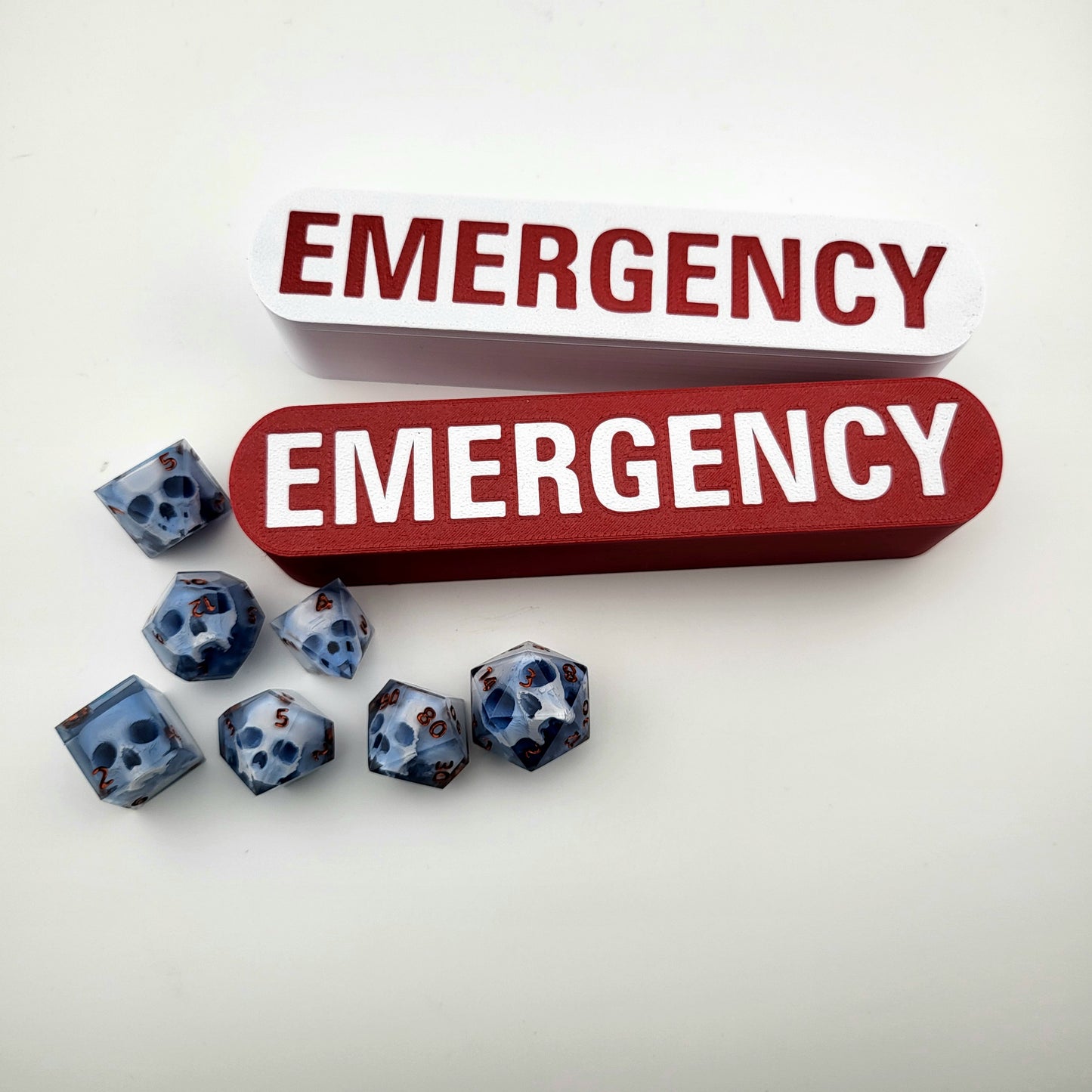 dice box white and red with the word emergency printed on it for dnd and dungeons and dragons games