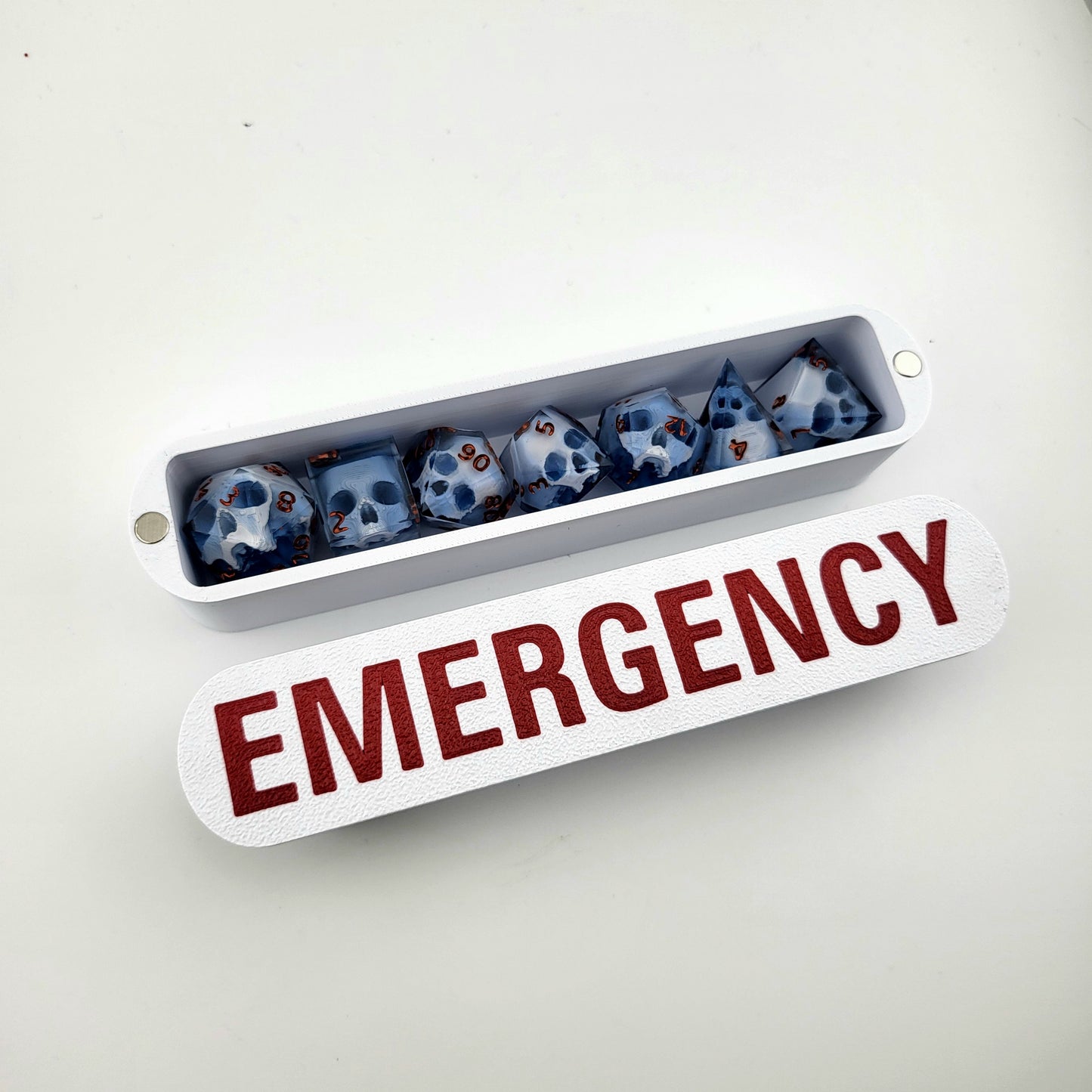 dice box white and red with the word emergency printed on it for dnd and dungeons and dragons games