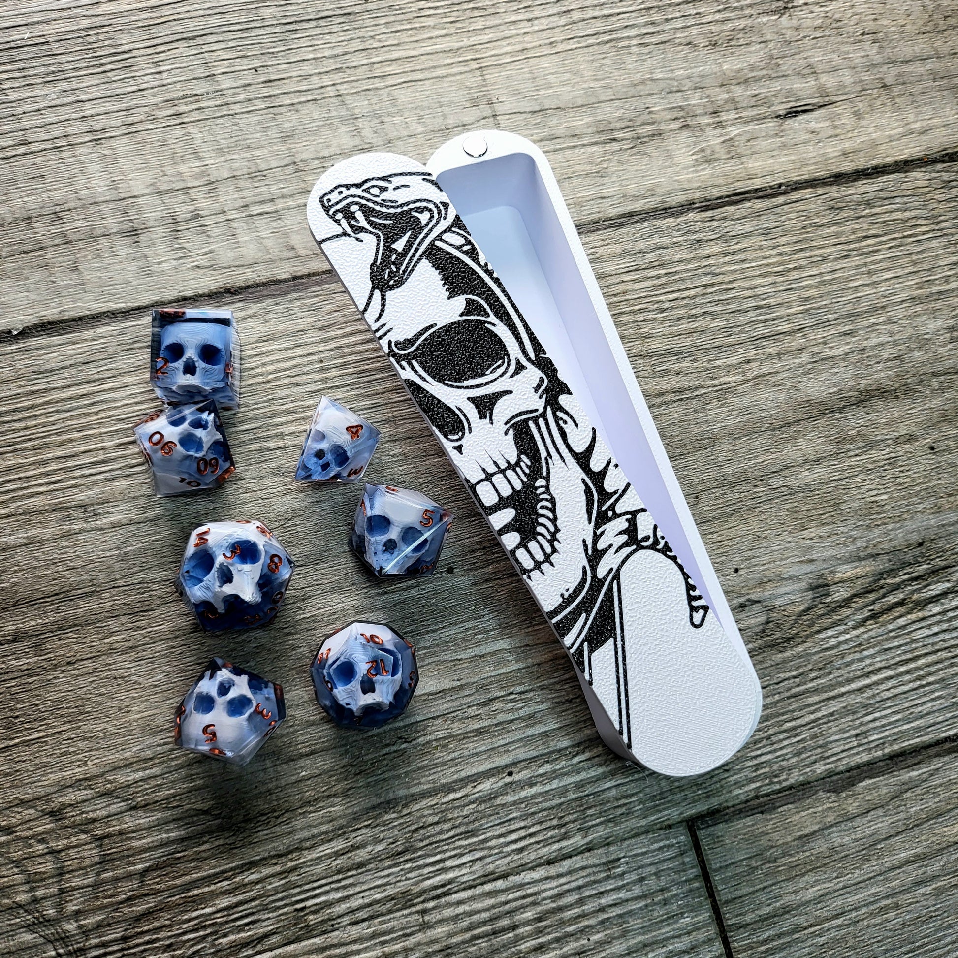 dice box white and black with the skull and snake printed on it for dnd and dungeons and dragons games