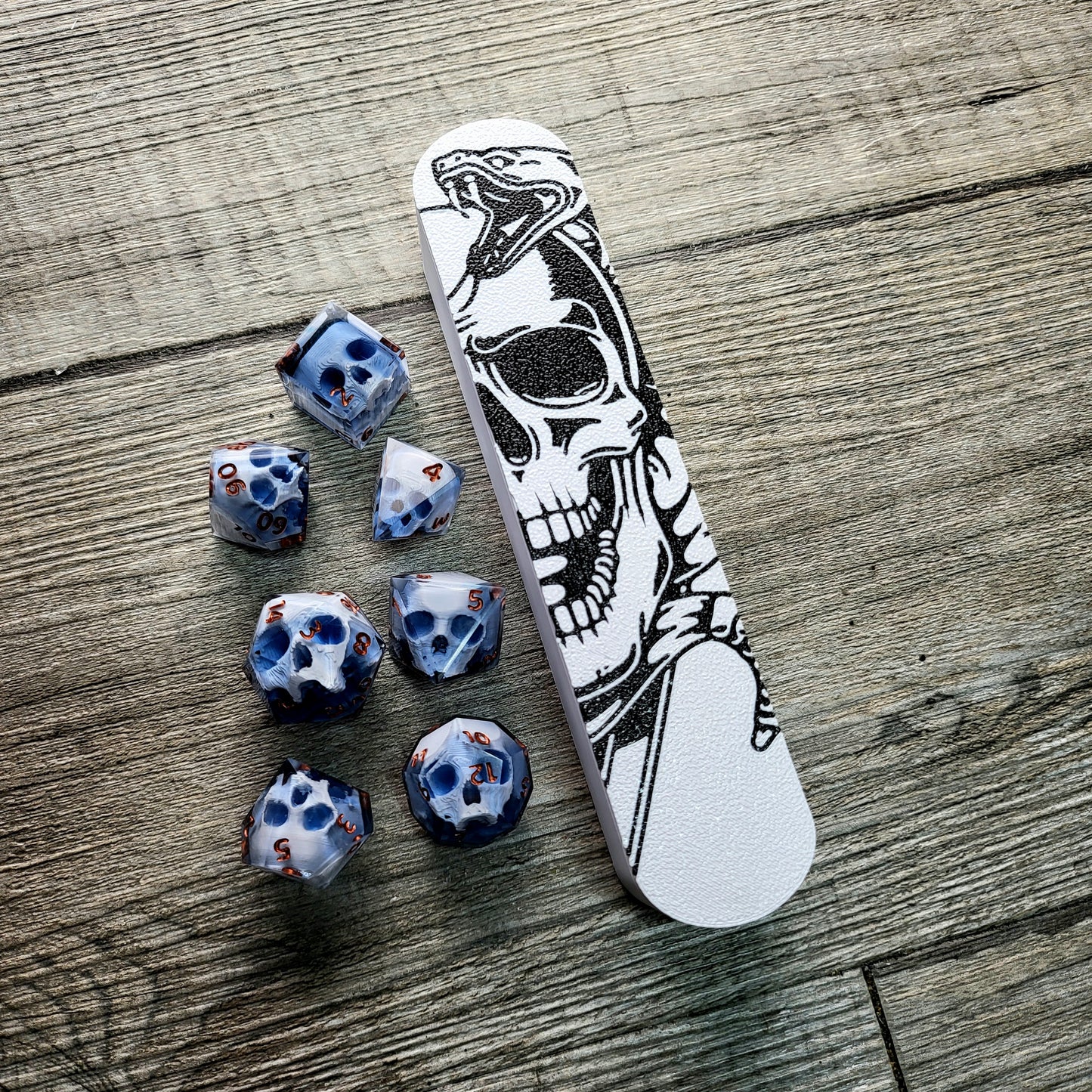 dice box white and black with the skull and snake printed on it for dnd and dungeons and dragons games