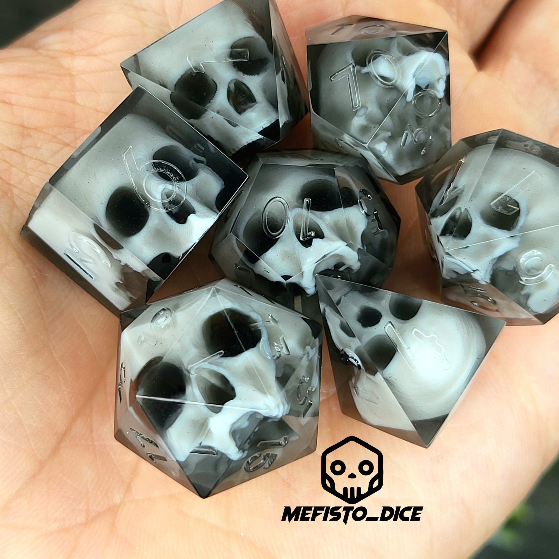 Handmade polyhedral dice set for Dungeons & Dragons (D&D) and tabletop RPGs, crafted in black resin with white skulls embedded inside