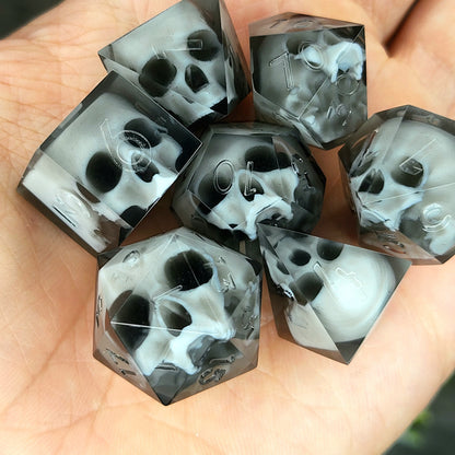 Handmade polyhedral dice set for Dungeons & Dragons (D&D) and tabletop RPGs, crafted in black resin with white skulls embedded inside