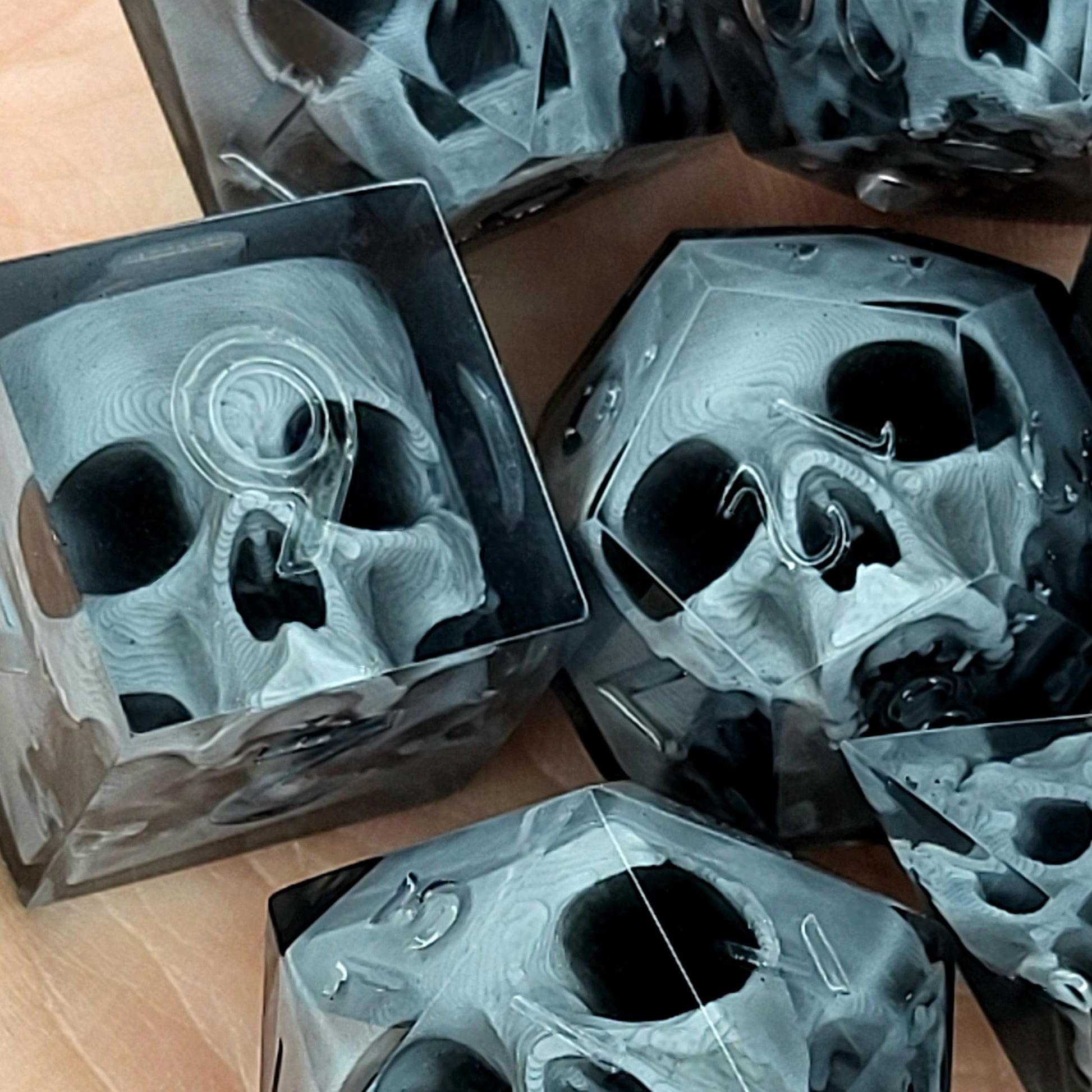 Black translucent polyhedral resin dice set with embedded red skulls inside, perfect for D&D (Dungeons & Dragons) and dark fantasy tabletop RPG campaigns