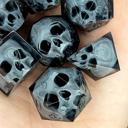 Black translucent polyhedral resin dice set with embedded red skulls inside, perfect for D&D (Dungeons & Dragons) and dark fantasy tabletop RPG campaigns