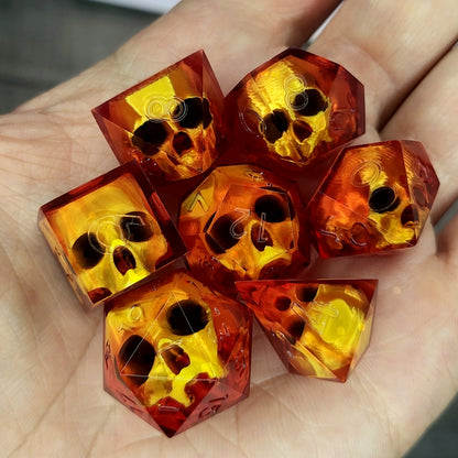 Handmade translucent red resin dice set with embedded skull designs resting in a hand. Gothic RPG polyhedral dice for Dungeons & Dragons and tabletop gaming with dark fantasy aesthetic