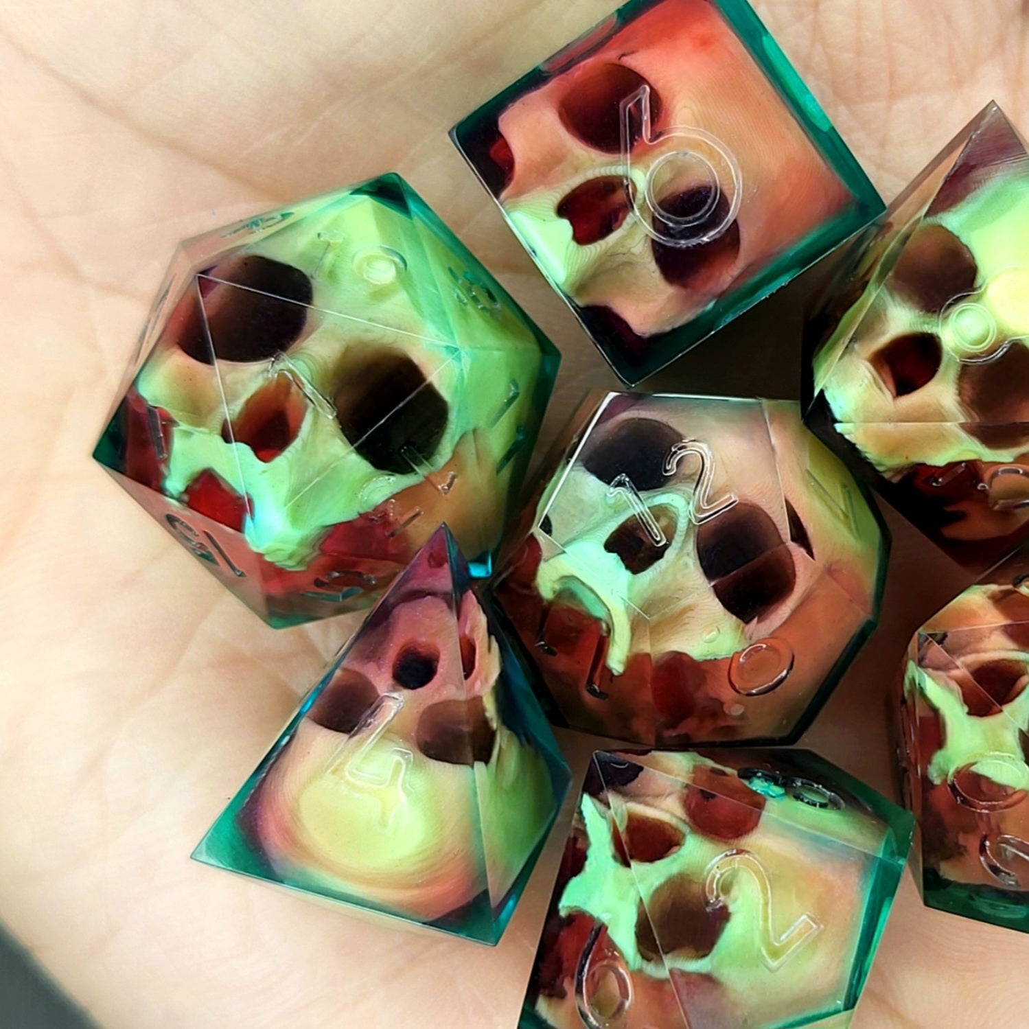 Handmade sharp edge resin dice set with floating skull design in transparent green and red resin