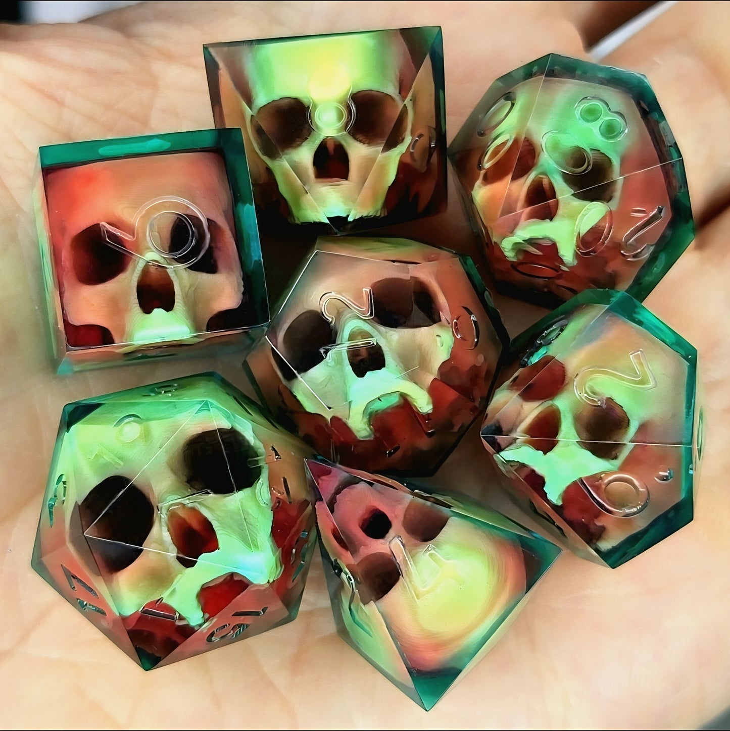 Handmade sharp edge resin dice set with floating skull design in transparent green and red resin