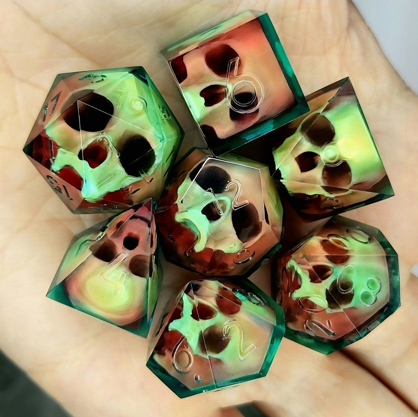 Handmade sharp edge resin dice set with floating skull design in transparent green and red resin