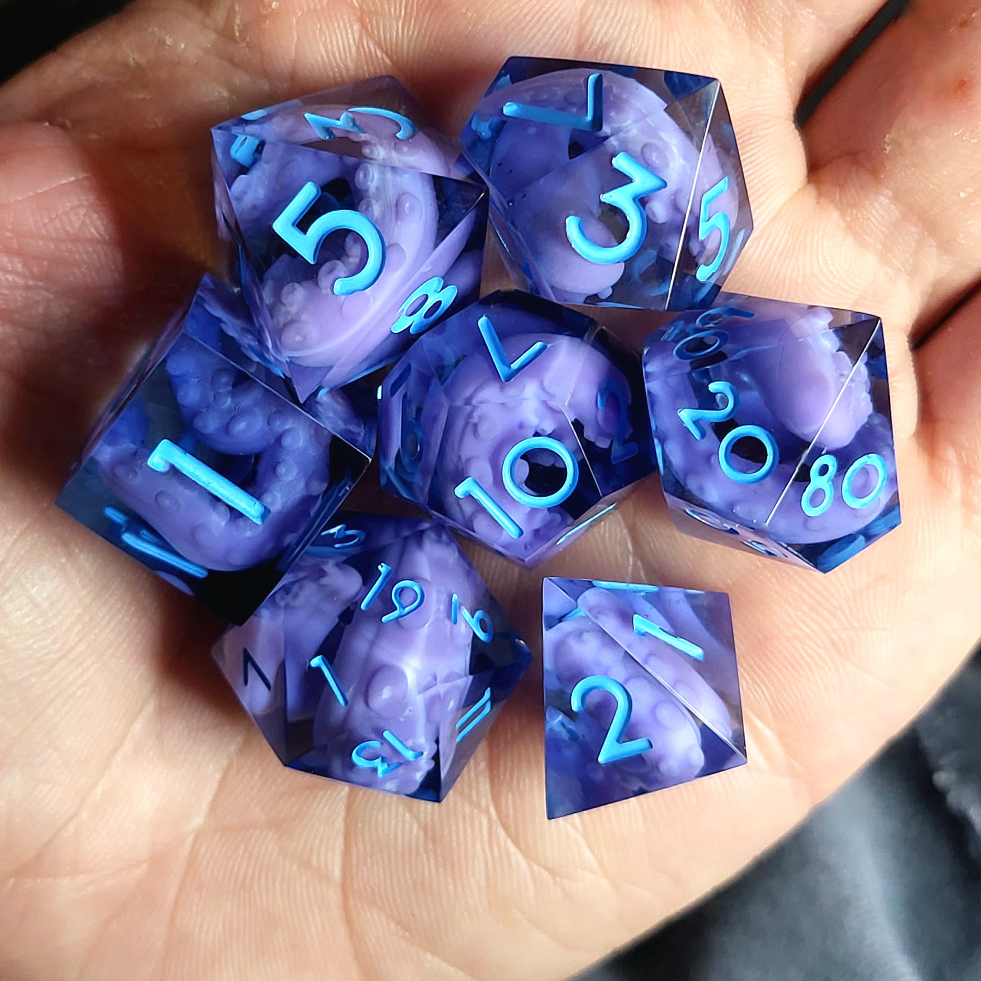 Dice set with purple tentacles inside and blue numbers for play dnd , dungeons and dragons and Call of Cthulhu
